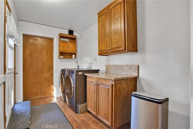 laundry room featuring washing machine and dryer and cabinets