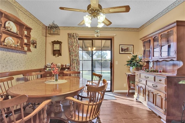 dining room with ceiling fan and a textured ceiling