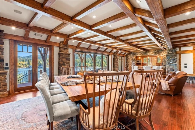 dining room with hardwood / wood-style flooring and beamed ceiling