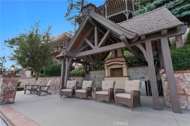 view of patio / terrace featuring a gazebo and an outdoor fireplace