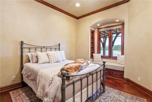 bedroom with dark wood-type flooring and ornamental molding