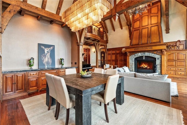 dining room featuring hardwood / wood-style flooring, high vaulted ceiling, and beamed ceiling