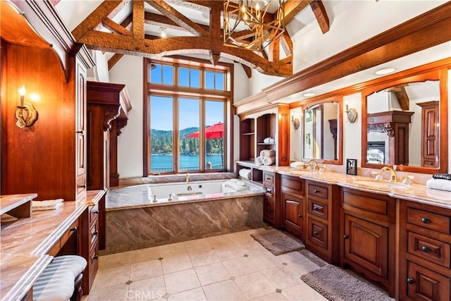 bathroom featuring a water and mountain view, tiled tub, vanity, high vaulted ceiling, and beam ceiling