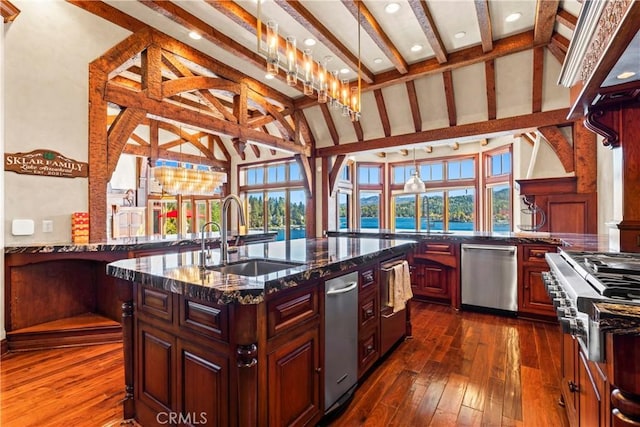 kitchen with dark stone countertops, stainless steel dishwasher, lofted ceiling with beams, sink, and a chandelier