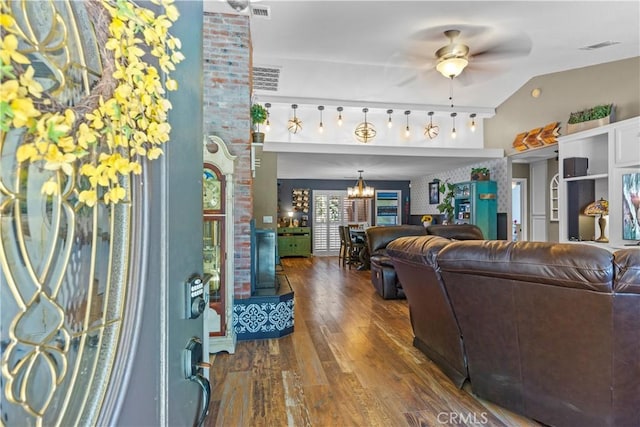 living room with dark hardwood / wood-style floors and ceiling fan with notable chandelier