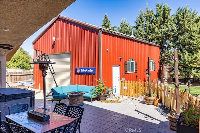 view of outbuilding with an outdoor living space with a fire pit