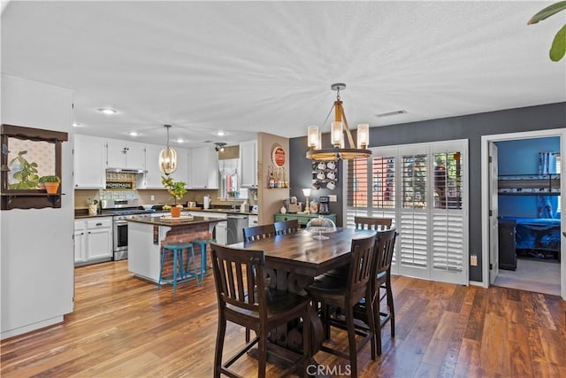 dining room with a notable chandelier and light hardwood / wood-style flooring