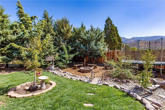 view of yard featuring a mountain view and a trampoline