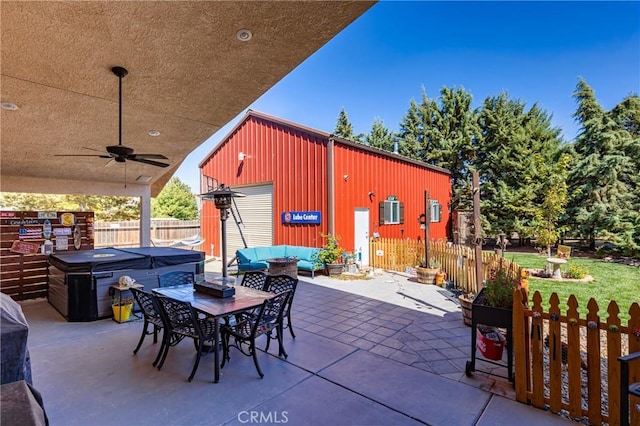 view of patio / terrace featuring ceiling fan and an outbuilding