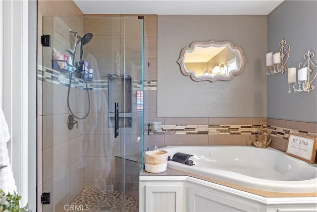 bathroom featuring separate shower and tub