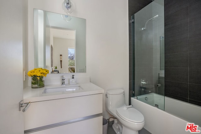 full bathroom with vanity, toilet, and bath / shower combo with glass door