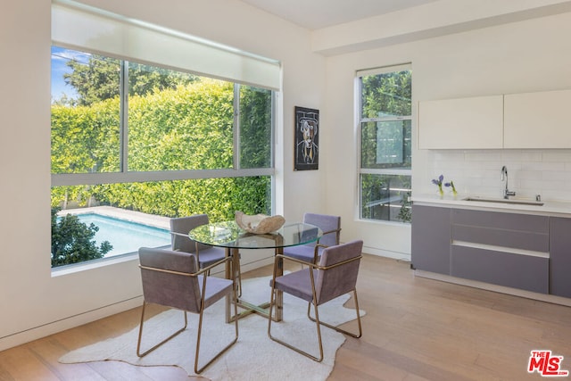 dining space featuring light hardwood / wood-style floors and sink