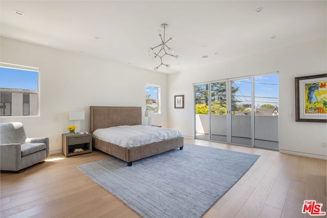 bedroom with access to outside and light hardwood / wood-style floors