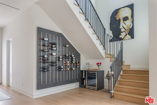 wine cellar featuring hardwood / wood-style flooring and bar