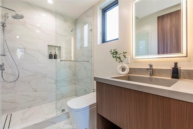 bathroom featuring vanity, toilet, and walk in shower