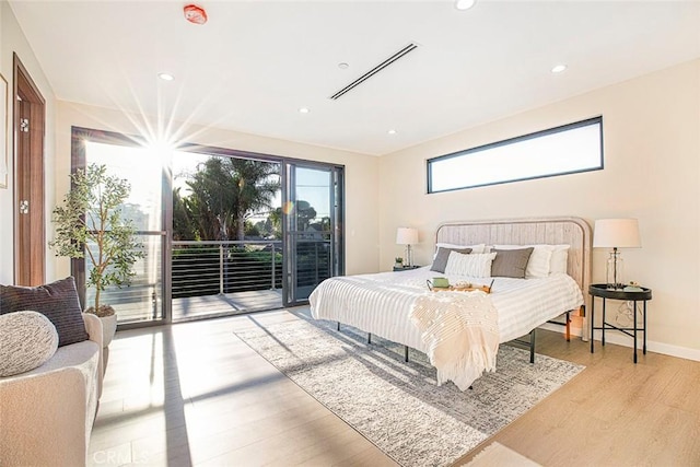 bedroom featuring light hardwood / wood-style floors and access to exterior