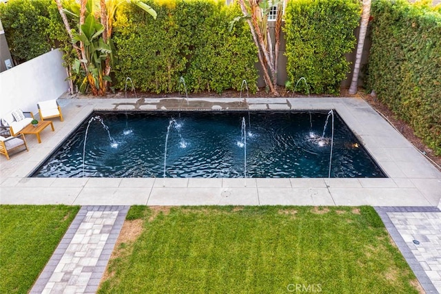 view of swimming pool featuring a lawn and pool water feature