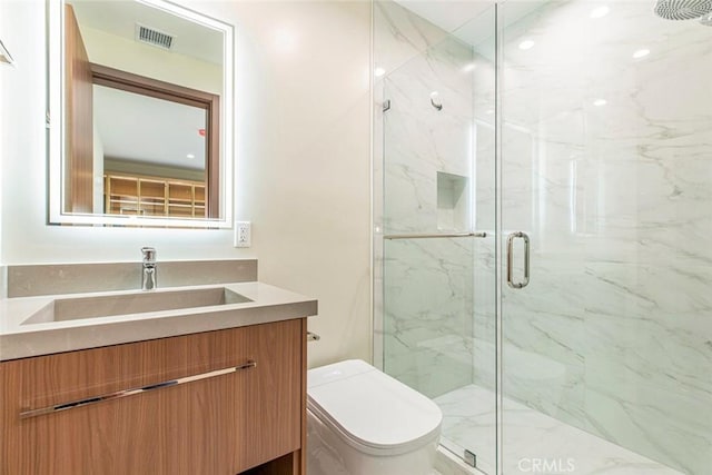 bathroom with vanity, toilet, and an enclosed shower