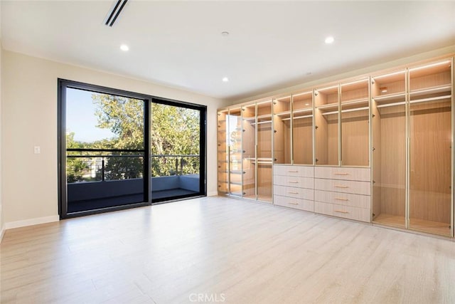 walk in closet featuring light hardwood / wood-style flooring