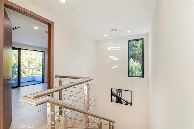 stairs featuring hardwood / wood-style flooring and a wealth of natural light