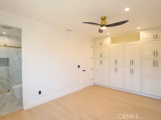 unfurnished bedroom with ceiling fan, connected bathroom, ornamental molding, a closet, and light wood-type flooring