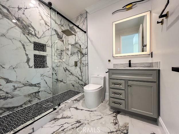 bathroom featuring toilet, vanity, baseboards, marble finish floor, and a marble finish shower