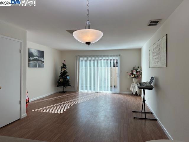 empty room with dark wood-type flooring