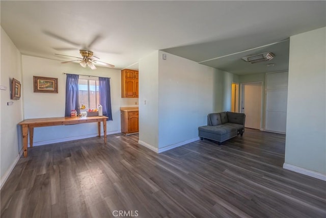 unfurnished room featuring dark wood-type flooring and ceiling fan