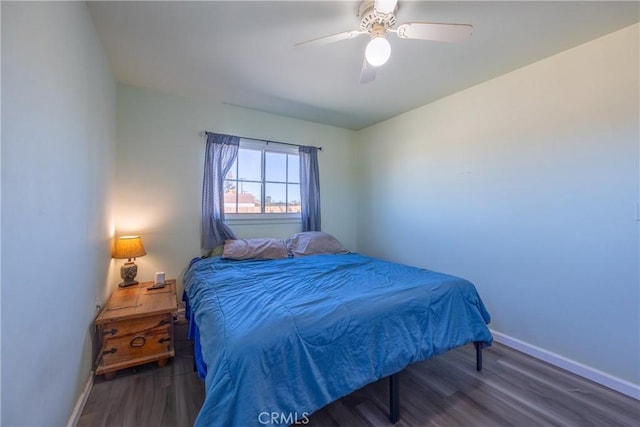 bedroom featuring ceiling fan and dark hardwood / wood-style flooring