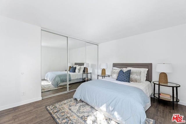 bedroom featuring a closet and dark hardwood / wood-style floors