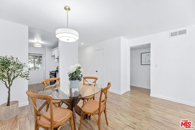 dining space with light hardwood / wood-style flooring