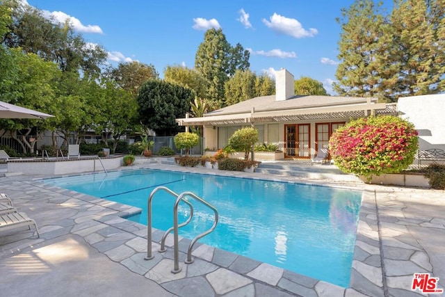 view of pool featuring a patio and french doors