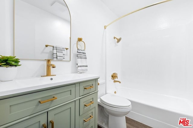 full bathroom with hardwood / wood-style floors, vanity, toilet, and shower / bathtub combination