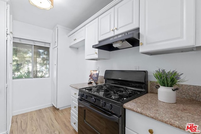 kitchen featuring white cabinets, light wood-type flooring, and gas stove