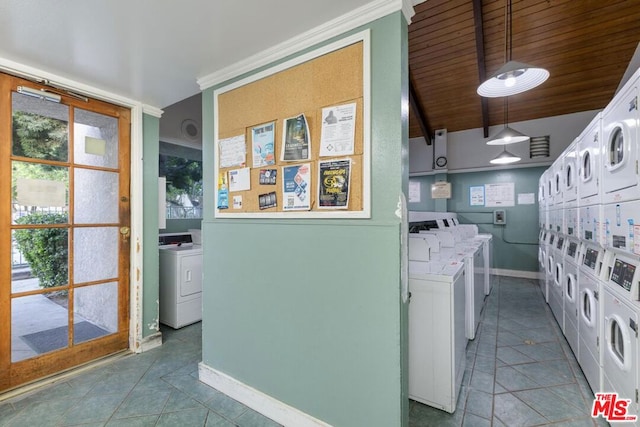 washroom featuring wood ceiling, stacked washer / dryer, and washer and clothes dryer