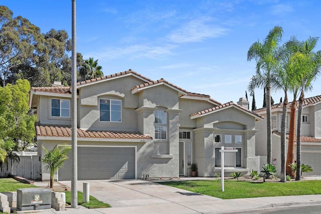 mediterranean / spanish-style home featuring a front yard and a garage