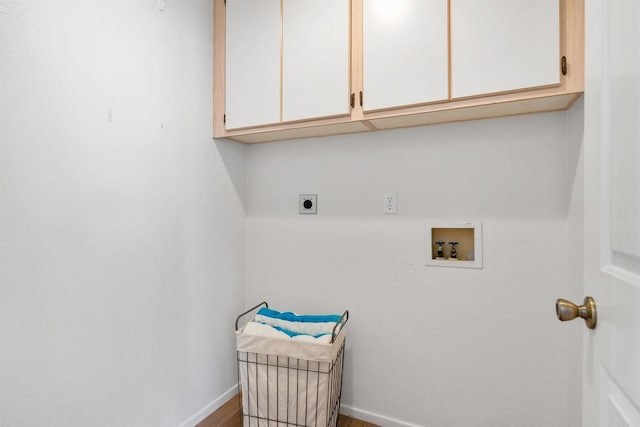 clothes washing area with hookup for an electric dryer, cabinets, hardwood / wood-style floors, and hookup for a washing machine