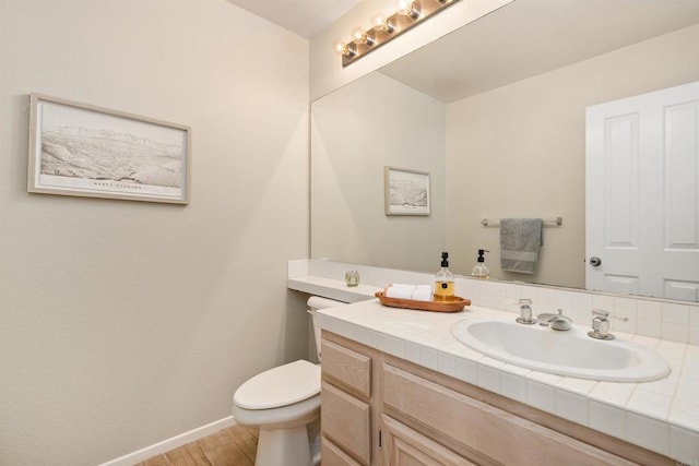 bathroom featuring hardwood / wood-style floors, vanity, and toilet