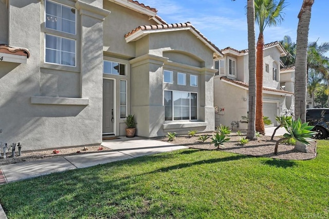 view of front of property with a garage and a front lawn