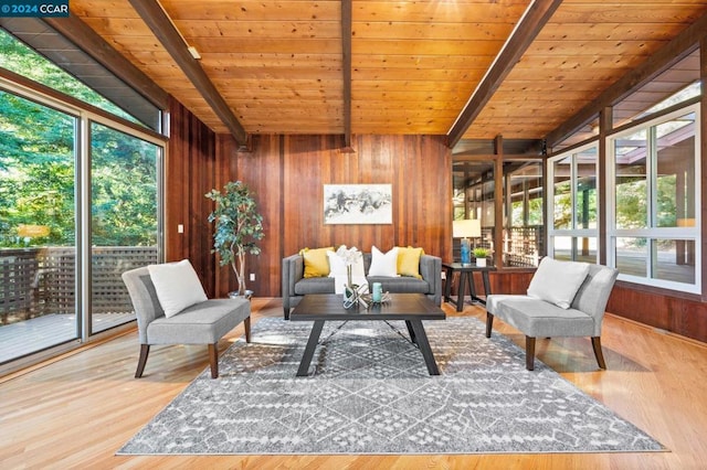 sunroom featuring vaulted ceiling with beams, wood ceiling, and a wealth of natural light