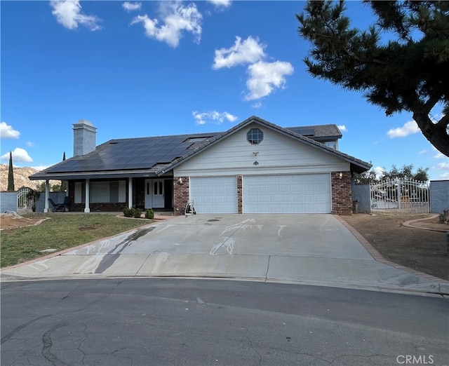 view of front of property with solar panels and a garage