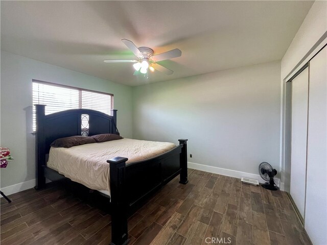 bedroom featuring dark hardwood / wood-style floors, a closet, and ceiling fan