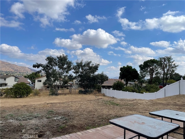 view of yard featuring a patio and a mountain view