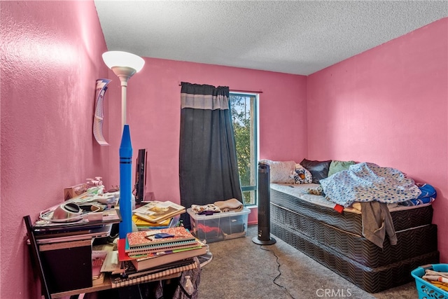 carpeted bedroom featuring a textured ceiling