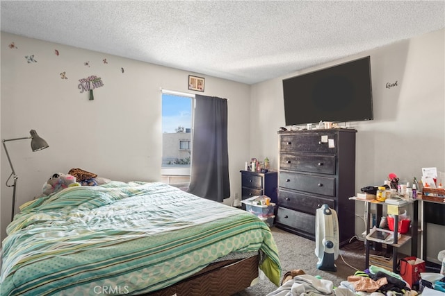 carpeted bedroom featuring a textured ceiling