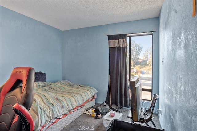 carpeted bedroom featuring a textured ceiling