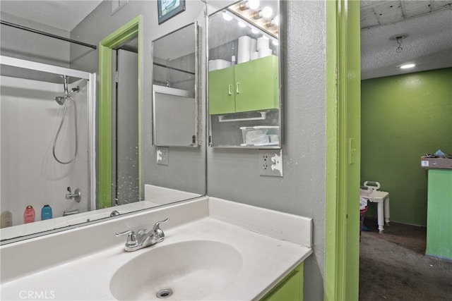 bathroom featuring vanity, a shower, a textured ceiling, and concrete flooring