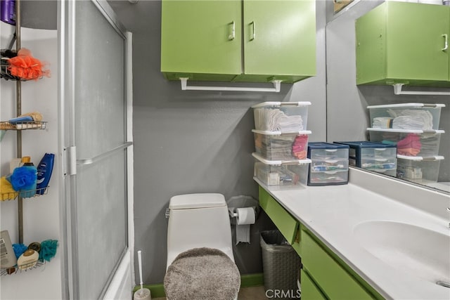 bathroom with vanity, an enclosed shower, and toilet