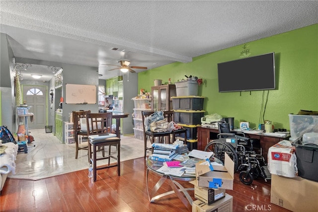 living room with a textured ceiling and hardwood / wood-style floors