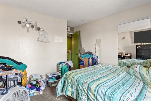 bedroom with a textured ceiling and carpet floors